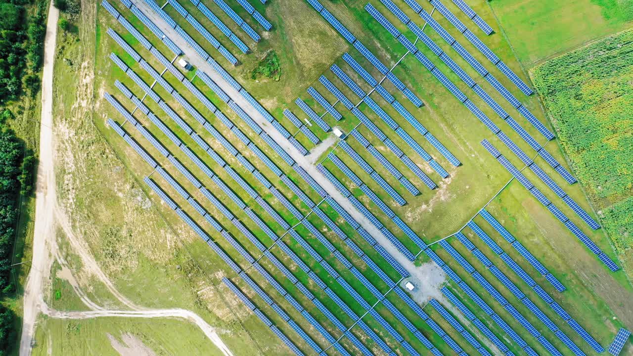 Ecological power plant in summer. Top view on the solar panels on the field. Renewable energy. Alternative source of electricity. Aerial view. Camera moves around.