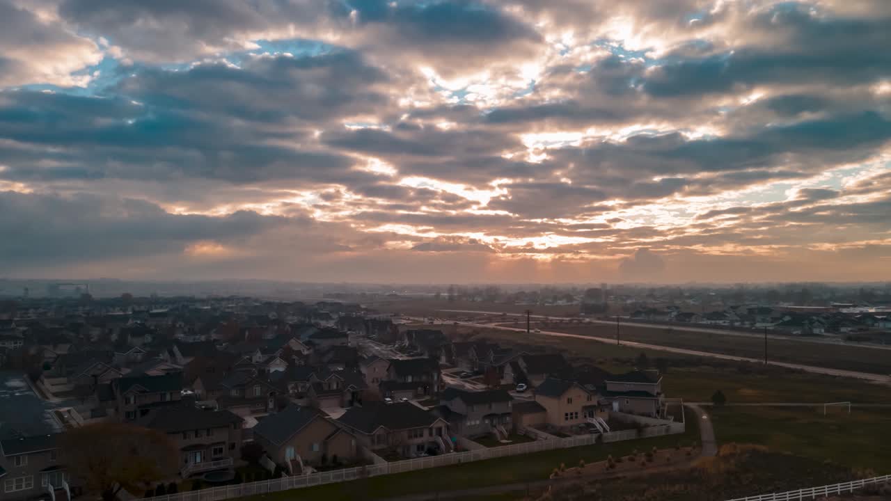 Fog and an overcast sky subdue the sunrise in this American suburb - aerial hyper lapse