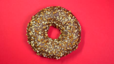 tasty sweet donut rotating on a plate. top view.