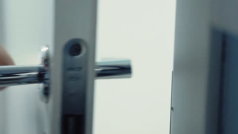 somebody opens the door with a door handle