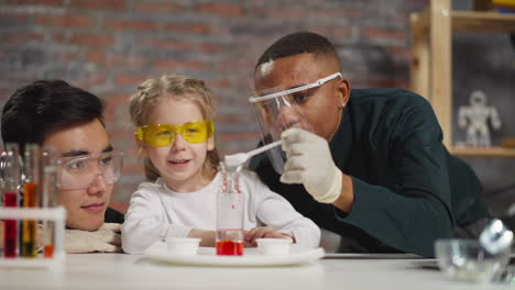 little girl talks to teacher looking at man with catalyst