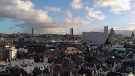 aerial forward flying from brussels grand place square to the town on sunny and cloudy day of january, belgium