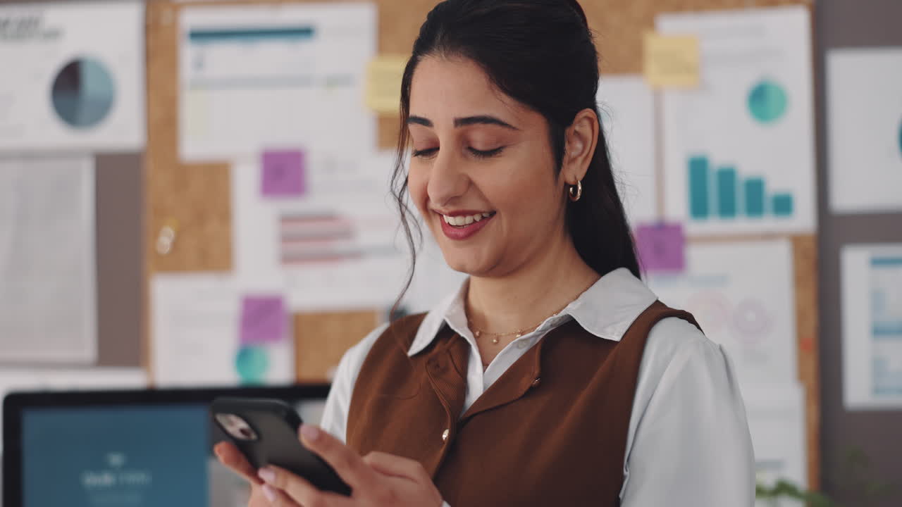 Business woman using smartphone in the office
