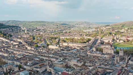 dolly back drone shot over old buildings in bath uk