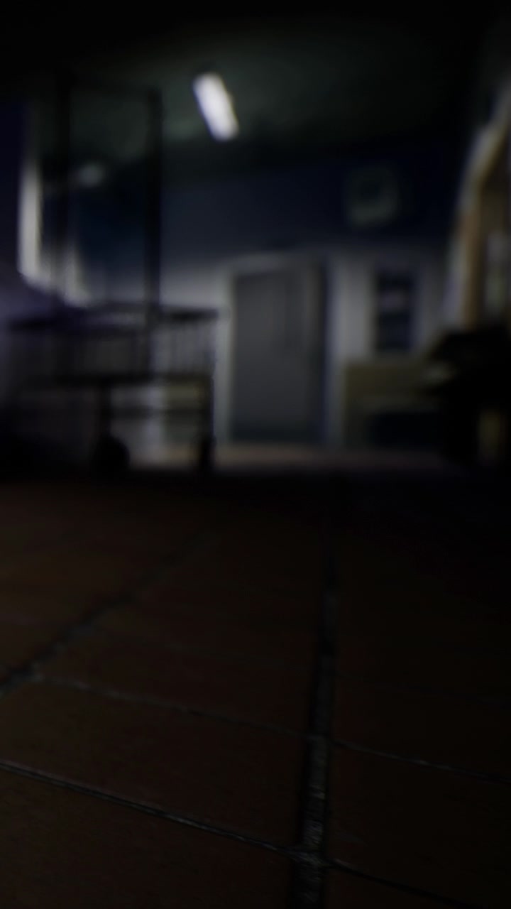 Low angle view of a dimly lit room with furniture and door
