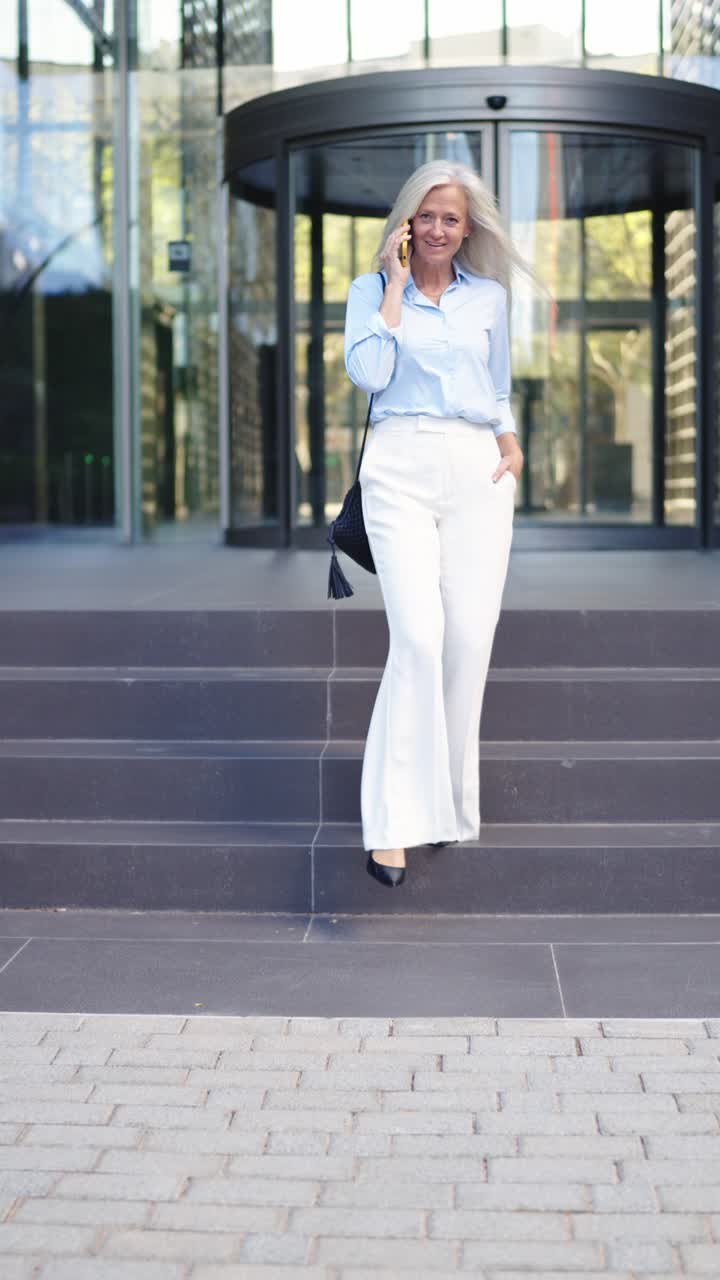 Businesswoman on the phone outside office building
