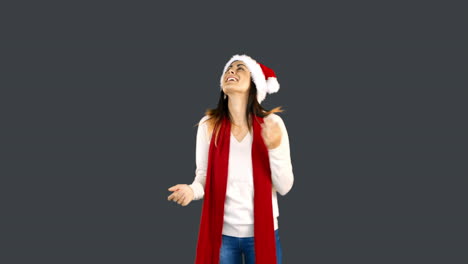 Woman-in-santa-hat-and-warm-clothing-looking-upwards