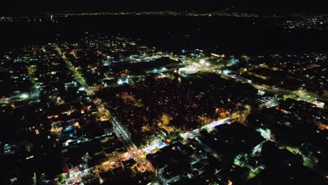 Aerial-view-of-people-lighting-candles-to-celebrate-the-dead-during-Dia-de-los-Muertos-in-Mexico-city---descending,-tilt,-drone-shot