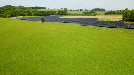 Granja-De-Energía-Solar-En-Campos-Verdes-Desde-Un-Alto-ángulo-De-Vista-En-Zielenica,-Polonia-Drone-Aéreo-Sobrevuela