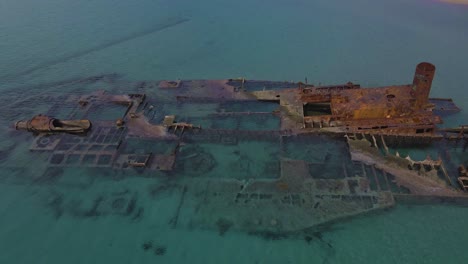 4k tilt up clip over a shipwreck in the tropical beach of epanomi, norhtern greece