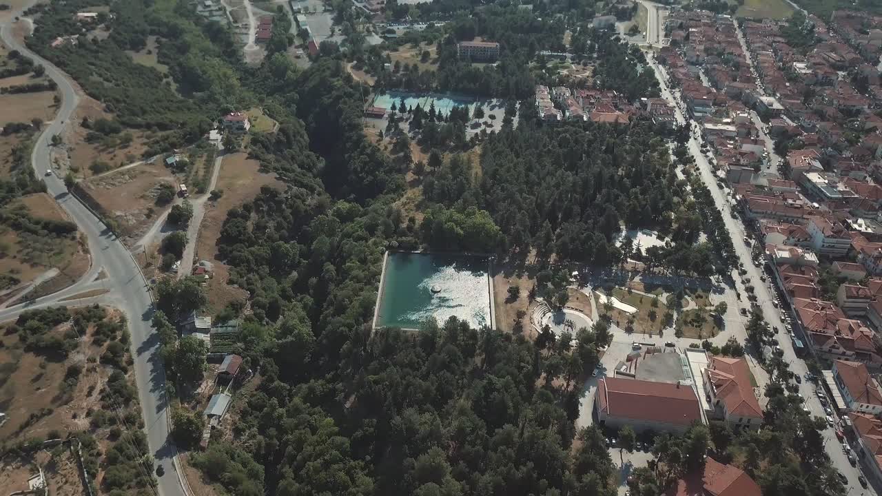 Aerial View of a Lake Surrounded by Forest and Town