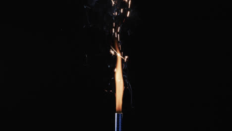 video of torch with yellow flame and sparks and copy space on black background