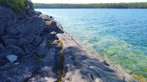 Drone-flight-close-to-the-ocean-waves-along-the-rocky-cliff