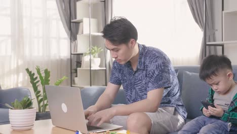 father working from home with son