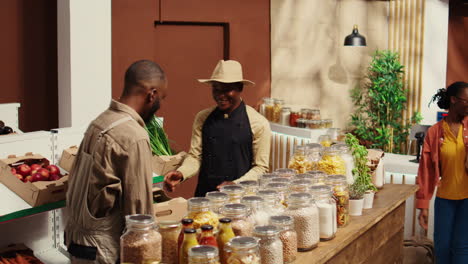 african american supplier giving fresh produce in crates to merchant