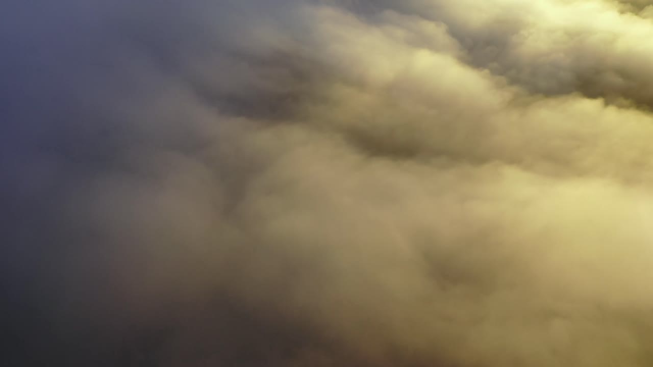 Drone footage of dam and countryside - Misty morning in cloudy hills