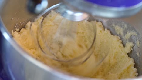 stand mixer mixing dough with a whisk. - closeup shot