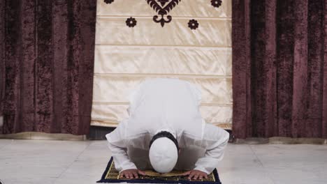 indian muslim man doing sujud and prayings to allah