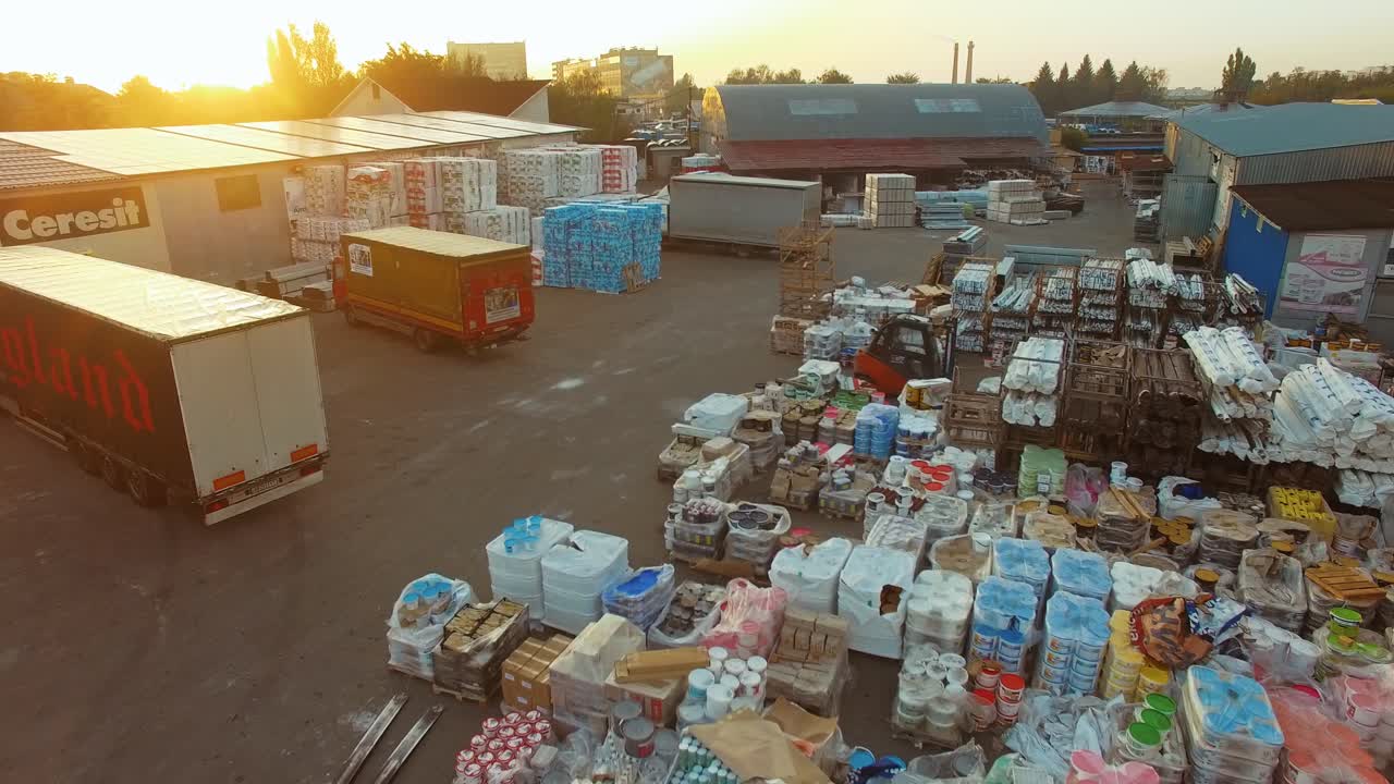 Logistics from above. Aerial view of warehouse with trucks