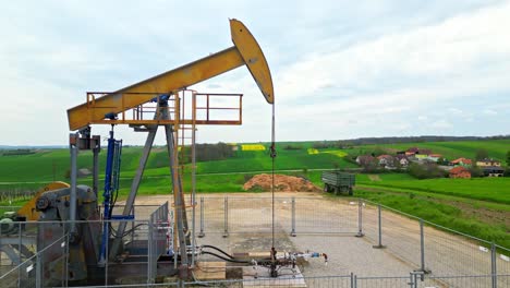 Oil-Pump-In-Field-In-The-Petroleum-Town-Of-Zistersdorf-In-Austria---drone-shot