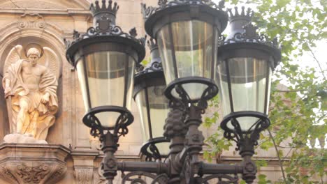 facade historic building with stone sculptures on background street lamp