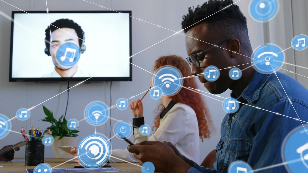 Animation of network of digital icons over diverse man and woman having a conference call at office