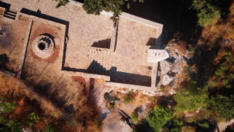 aerial drone view of ancient stone structures and well