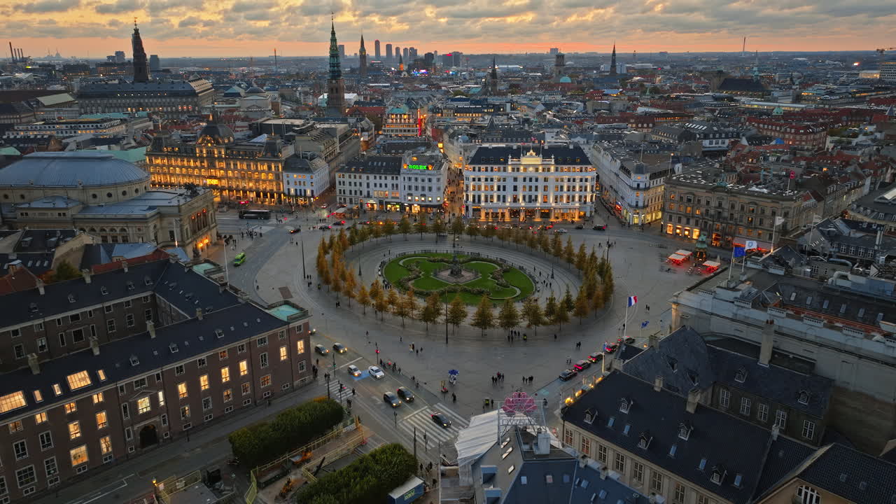 Aerial drone view of the Kongens Nytorv public square in Copenhagen, Denmark at night