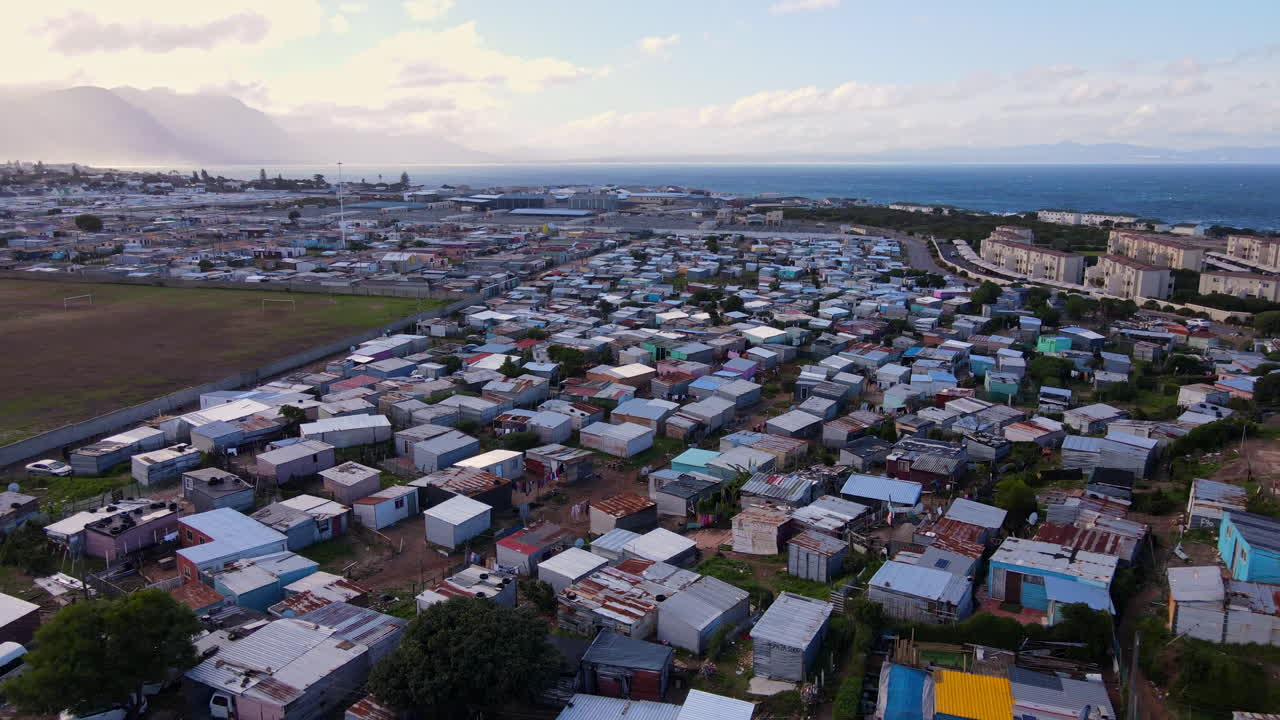 Informal township in coastal town Hermanus with makeshift tin houses, aerial