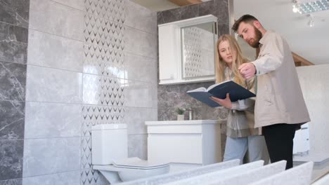 couple choosing bathroom tiles in a showroom