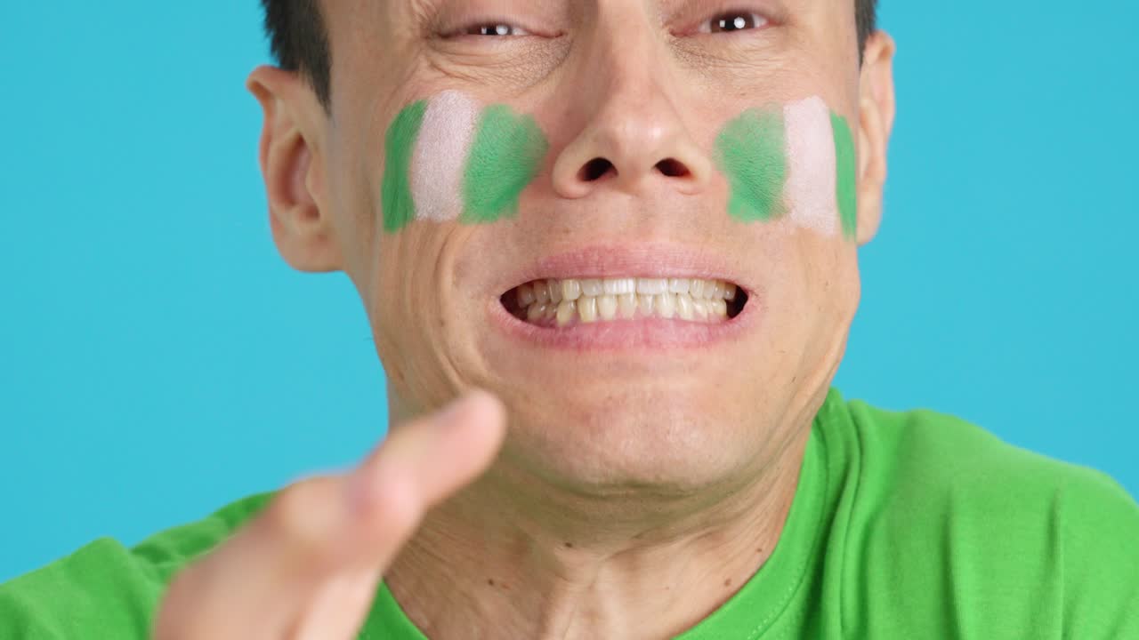 Very nervous man supporting nigerian team during a difficult match