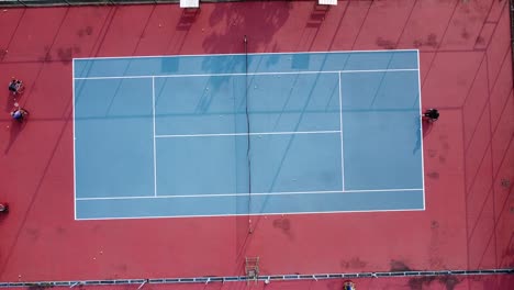 people in wheelchair playing tennis on court