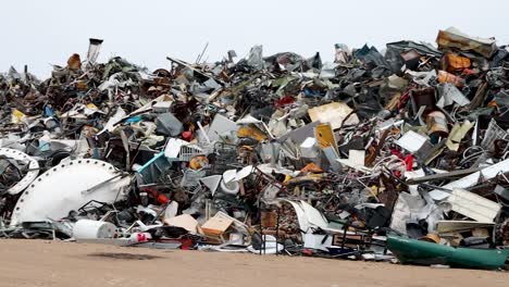 scrap metal junk pile in northern canada subarctic village of churchill manitoba pan left