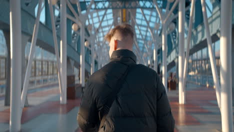 man walking on a modern bridge