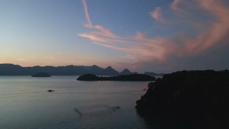 Colorful-hues-over-the-ocean,-islands-before-sunrise