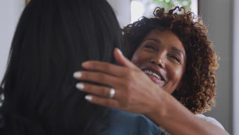 Loving-Senior-Mother-Hugging-Adult-Daughter-Indoors-At-Home