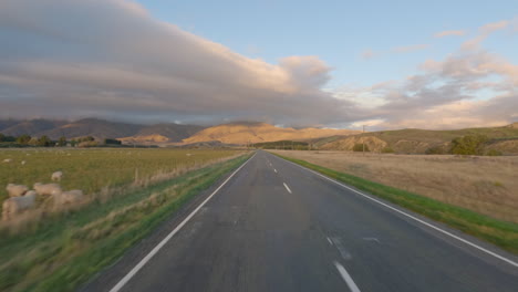 pov from car driving through the state highway 85 along the maniototo plain in otago, new zealand