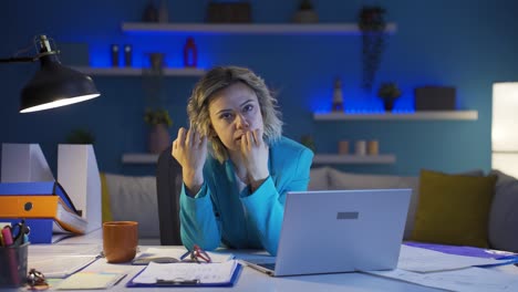 Mujer-Trabajadora-De-Oficina-En-Casa-Mordiéndose-Las-Uñas-Mirando-A-La-Cámara.