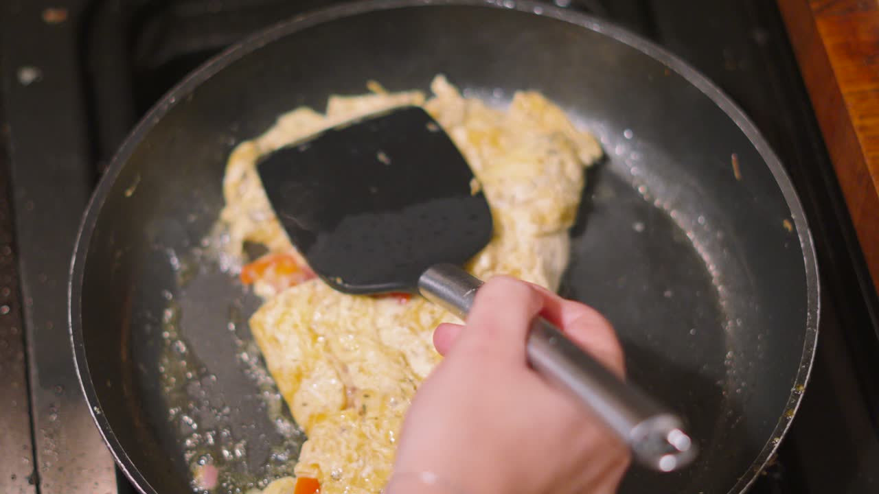Large Omelette Being Moved Around Pan After Flipping and Cooking Gently in Pan. Chef Using Turner to Move Dish Around to Cook Evenly. Tasty at Home Quick Food Example