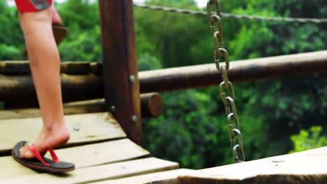 niño caminando por un puente en el patio de recreo