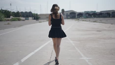 woman walking on empty city street