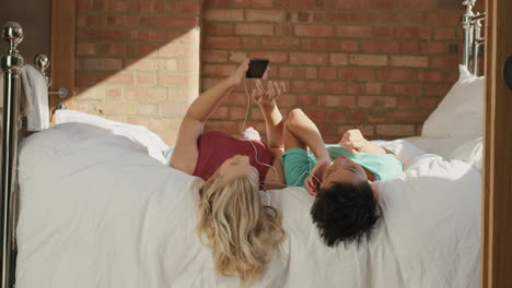 Girl-friends-listening-to-music-sharing-smart-phone