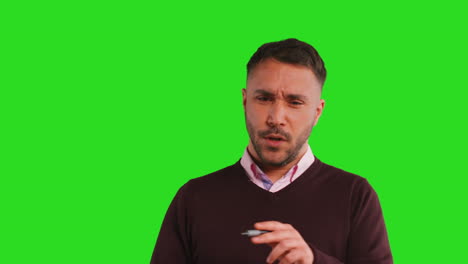 Close-Up-Studio-Portrait-Of-Mature-Male-Teacher-Talking-To-Class-Standing-Against-Green-Screen-Background-1