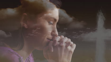 praying with hands clasped, woman with clouds and cross in background animation