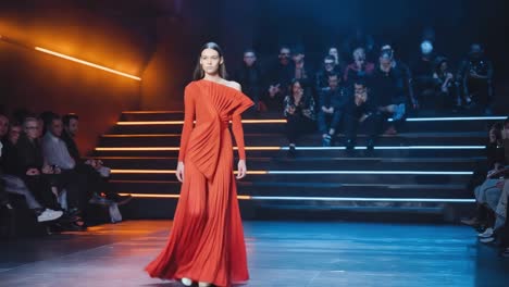 fashion show with model wearing a red dress