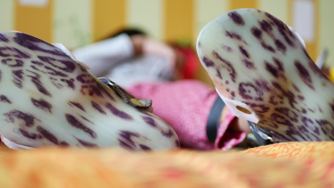 레오파드 프린트 정형 신발 을 착용 한 어린이 의 다리 의 클로즈업