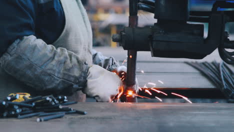 professional metalworker create metal construction from steel bars at factory