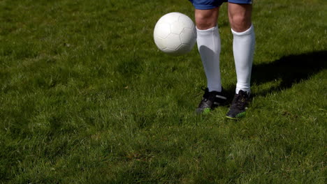 football player controlling the ball on grass