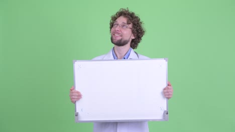 joven hombre guapo barbudo médico con cabello rizado