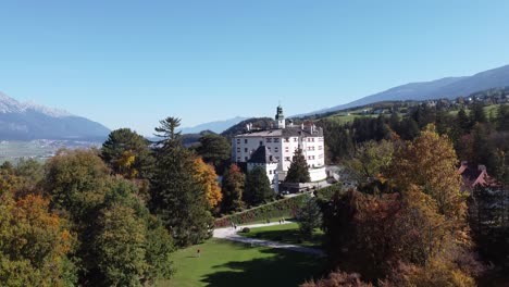 ambras castle in an aerial view from its outdoor garden in the middle of the alpine forests of the city of innsbruck in the tyrol region of austria